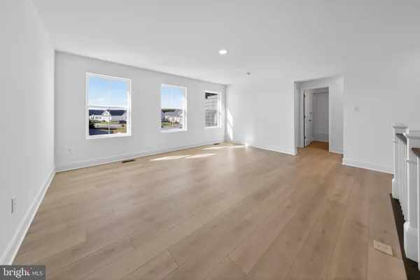 an empty room with windows and closet