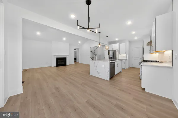 a view of kitchen with refrigerator microwave and wooden floor