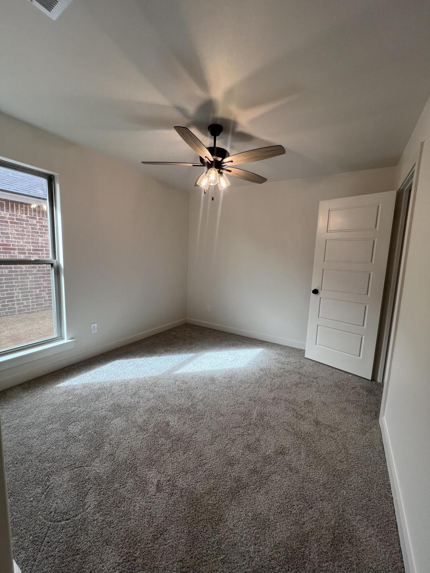 3105 140th Street Lubbock, TX 79423 - Photo 13 of 23 an empty room with windows and fan