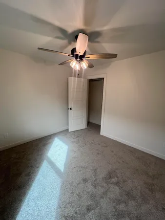 a view of a chandelier fan in a room