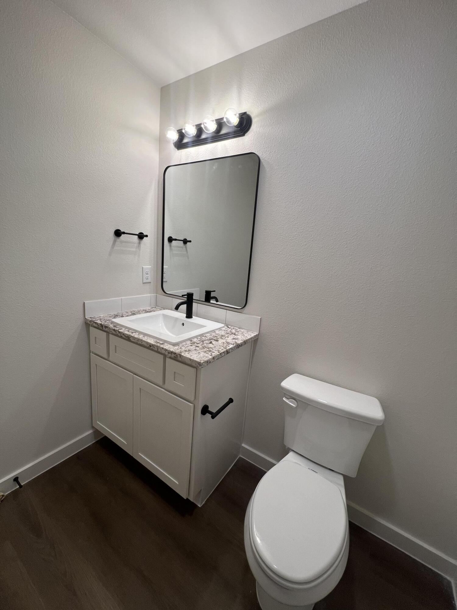 3105 140th Street Lubbock, TX 79423 - Photo 15 of 23 a bathroom with a toilet sink and mirror