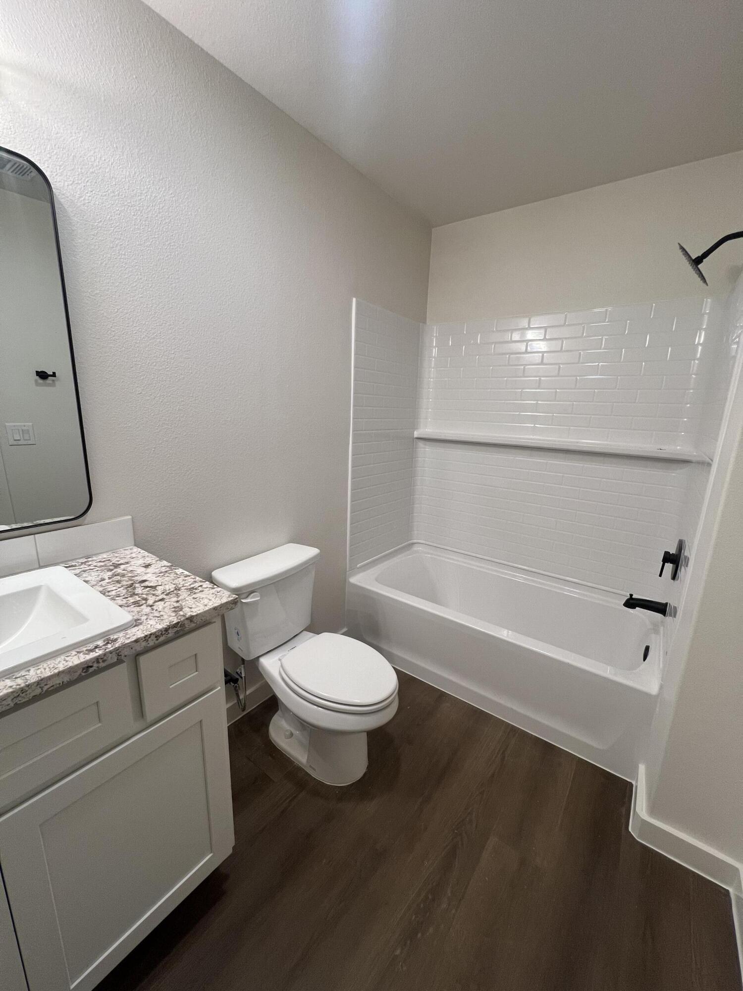 3105 140th Street Lubbock, TX 79423 - Photo 16 of 23 a bathroom with a granite countertop sink toilet and shower
