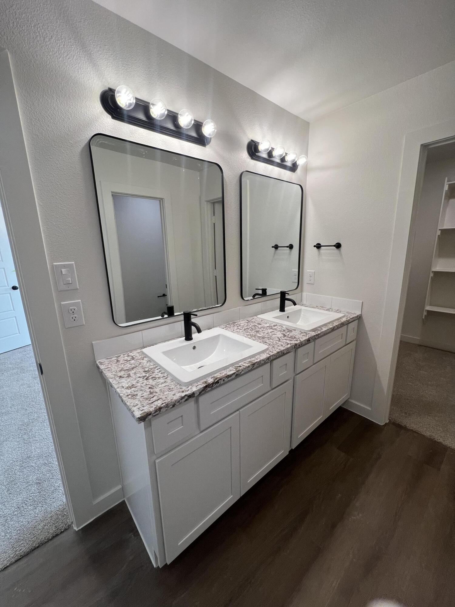 3105 140th Street Lubbock, TX 79423 - Photo 20 of 23 a bathroom with a double vanity sink and a mirror