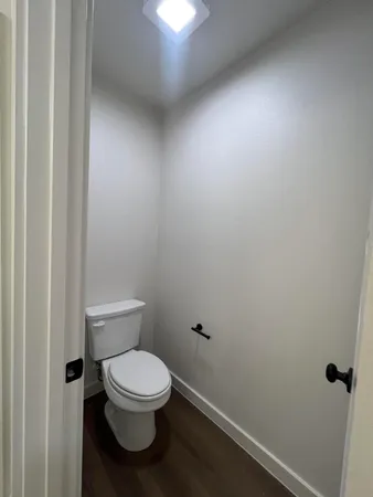 a white toilet sitting next to a white sink