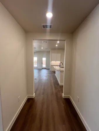 a view of a hallway with wooden floor