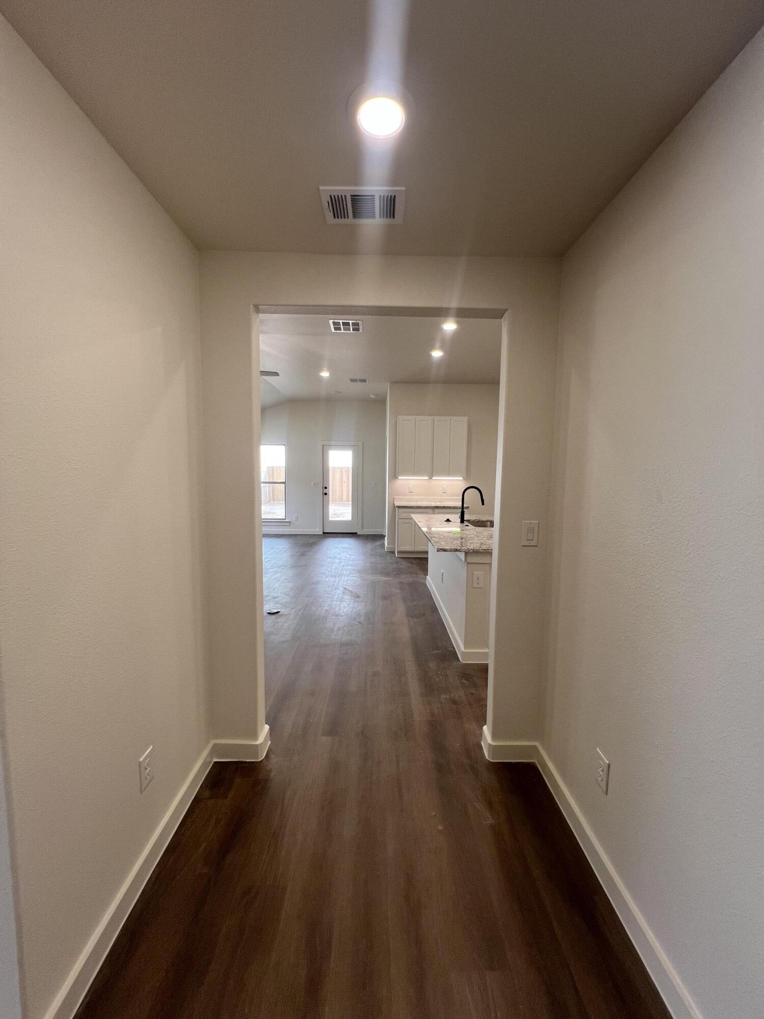 3105 140th Street Lubbock, TX 79423 - Photo 3 of 23 a view of a hallway with wooden floor