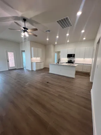 a view of a kitchen with a sink and a refrigerator