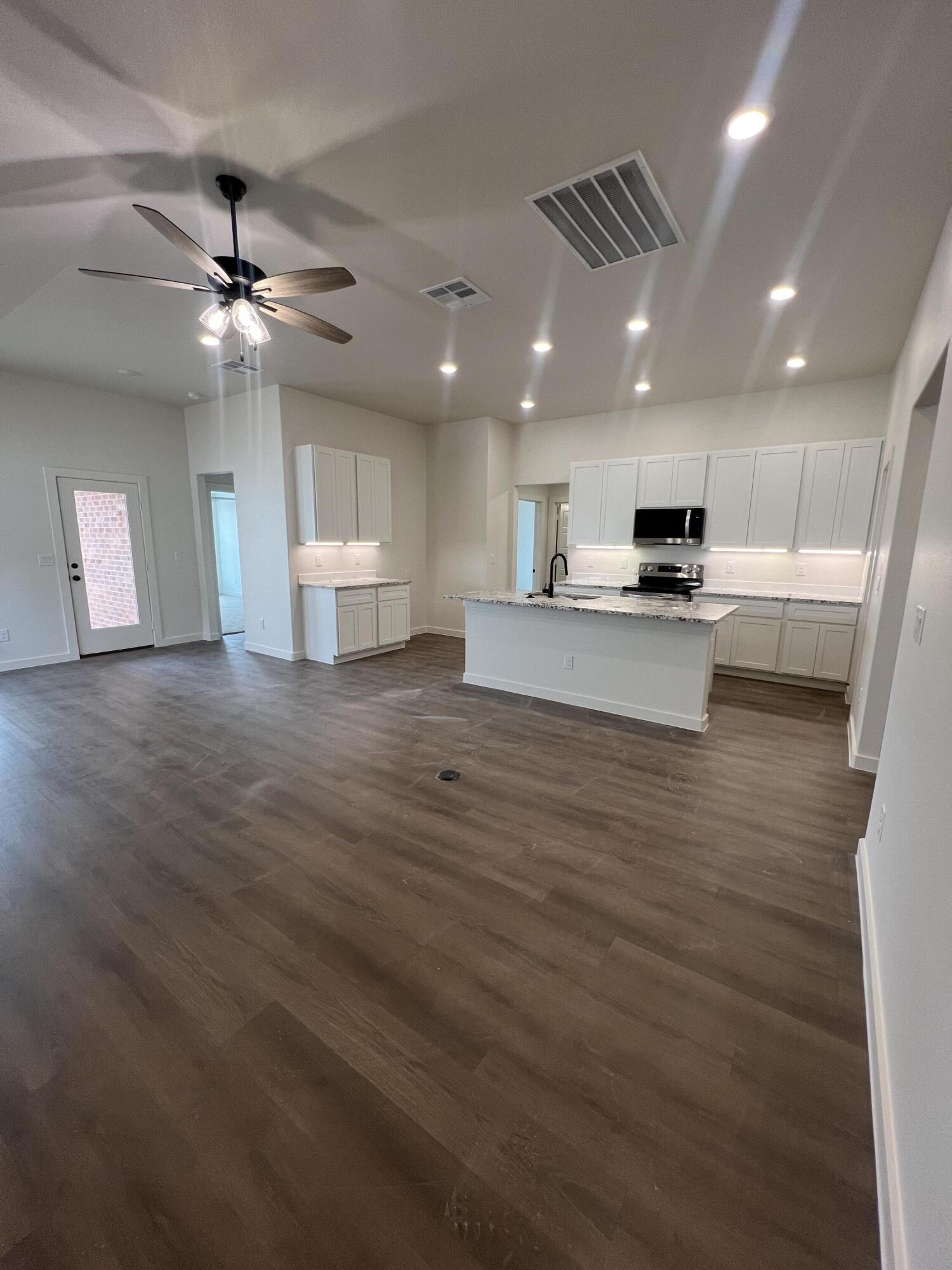 3105 140th Street Lubbock, TX 79423 - Photo 5 of 23 a view of a kitchen with a sink and a refrigerator