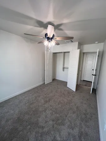 a view of a chandelier fan and closet in a room