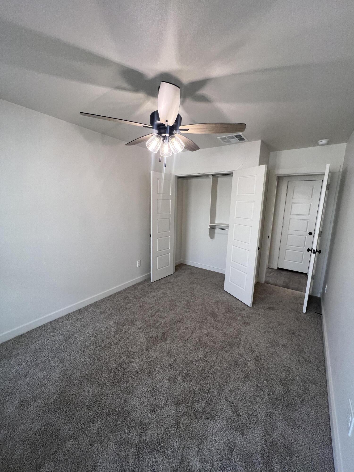 3105 140th Street Lubbock, TX 79423 - Photo 10 of 23 a view of a chandelier fan and closet in a room