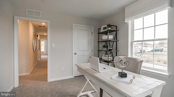 a view of a dining room that has a table and chairs in it