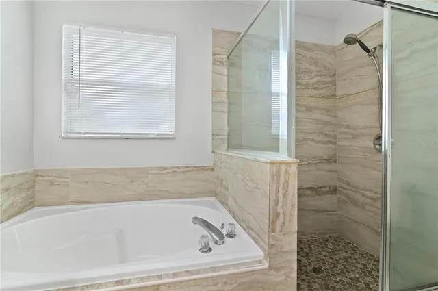 a bath tub sitting next to a shower