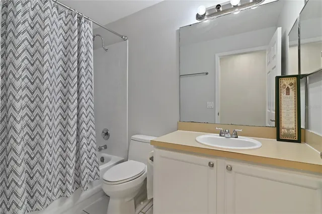 a bathroom with a sink toilet and mirror