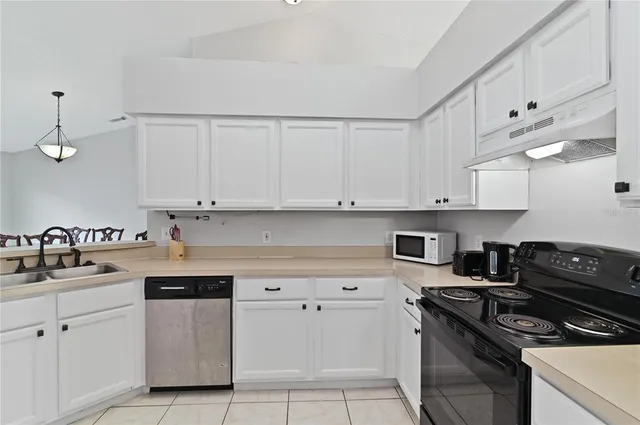 a kitchen with cabinets and appliances
