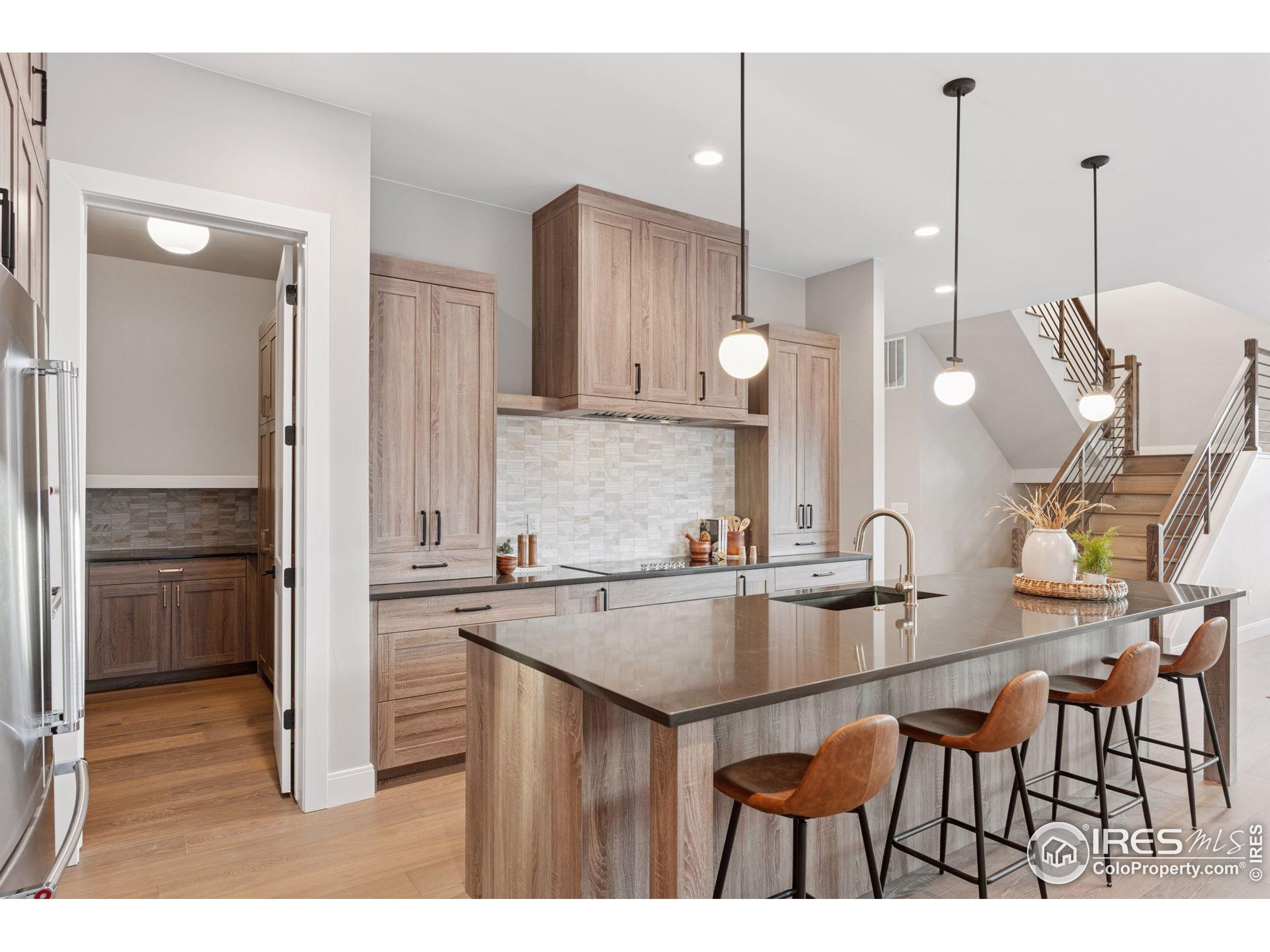 927 William Way Berthoud, CO 80513 - Photo 7 of 28 a kitchen with kitchen island granite countertop a sink cabinets and stainless steel appliances
