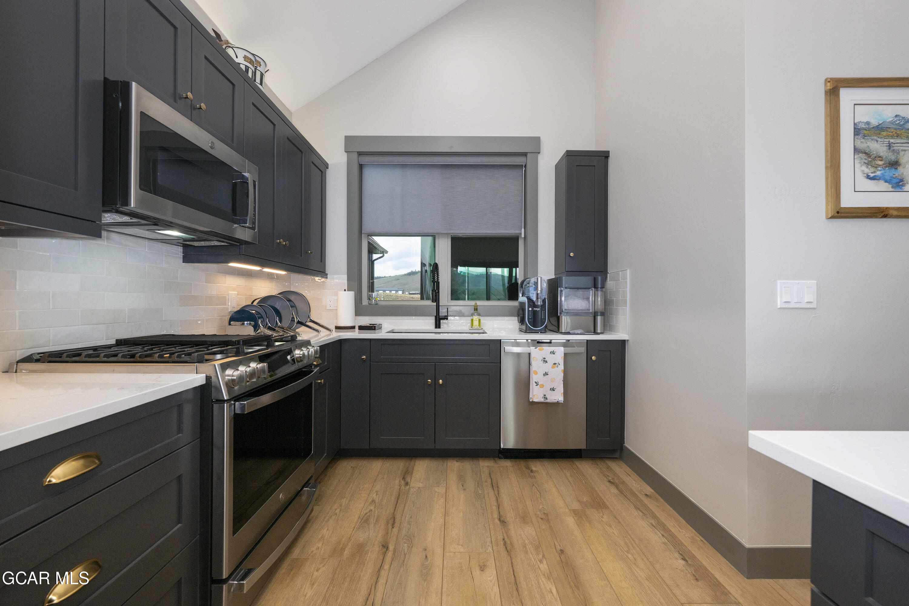 154 Eagle Ridge Drive Granby, CO 80446 - Photo 23 of 59 a kitchen with stainless steel appliances granite countertop a stove a sink and a microwave