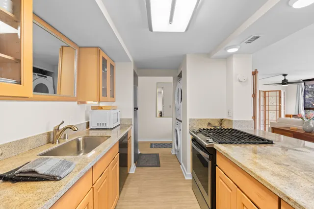 a kitchen that has a sink and a stove