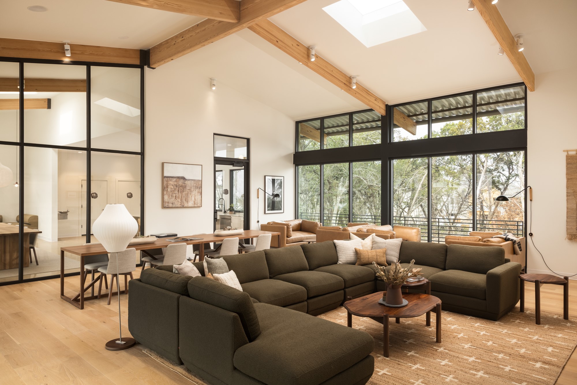 8107 Wilder Road Austin, TX 78736 - Photo 27 of 35 Natural light floods this spacious living area with vaulted ceilings and views of the surrounding trees.
