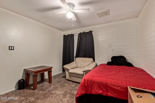 a bedroom with furniture and a flat screen tv