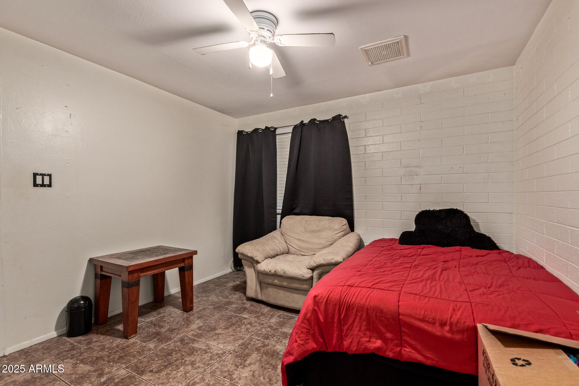5439 West Osborn Road Phoenix, AZ 85031 - Photo 11 of 22 a bedroom with two beds and a chandelier