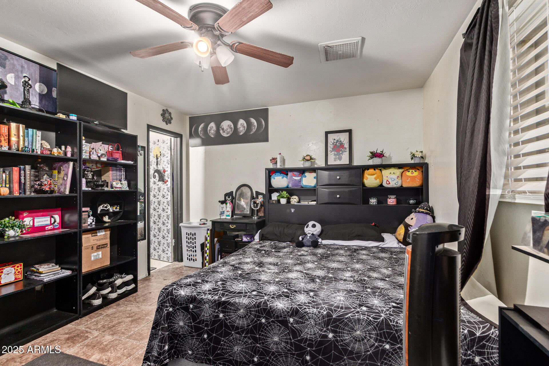 5439 West Osborn Road Phoenix, AZ 85031 - Photo 12 of 22 a bedroom with furniture and a flat screen tv