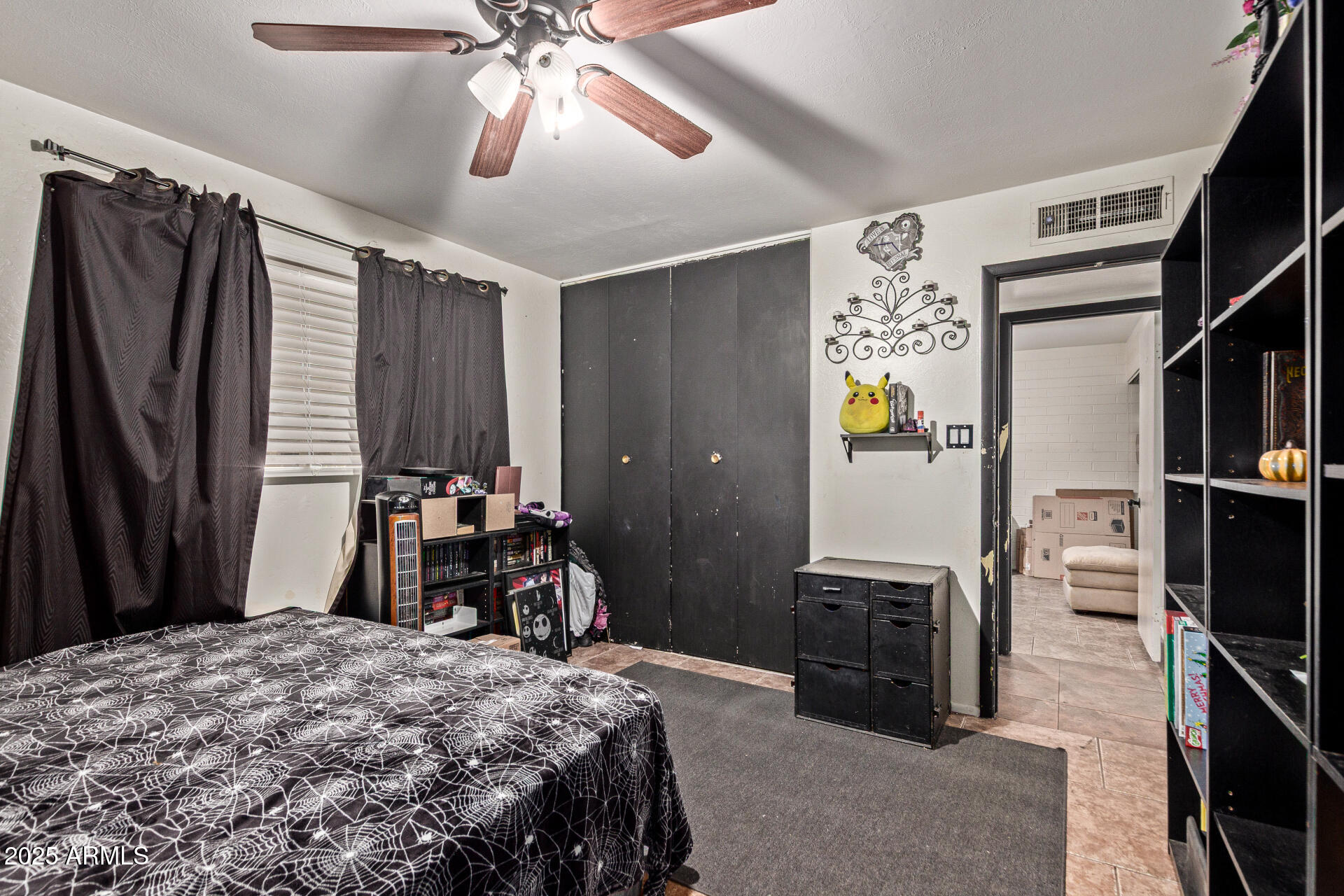 5439 West Osborn Road Phoenix, AZ 85031 - Photo 13 of 22 a bedroom with a bed and a chandelier
