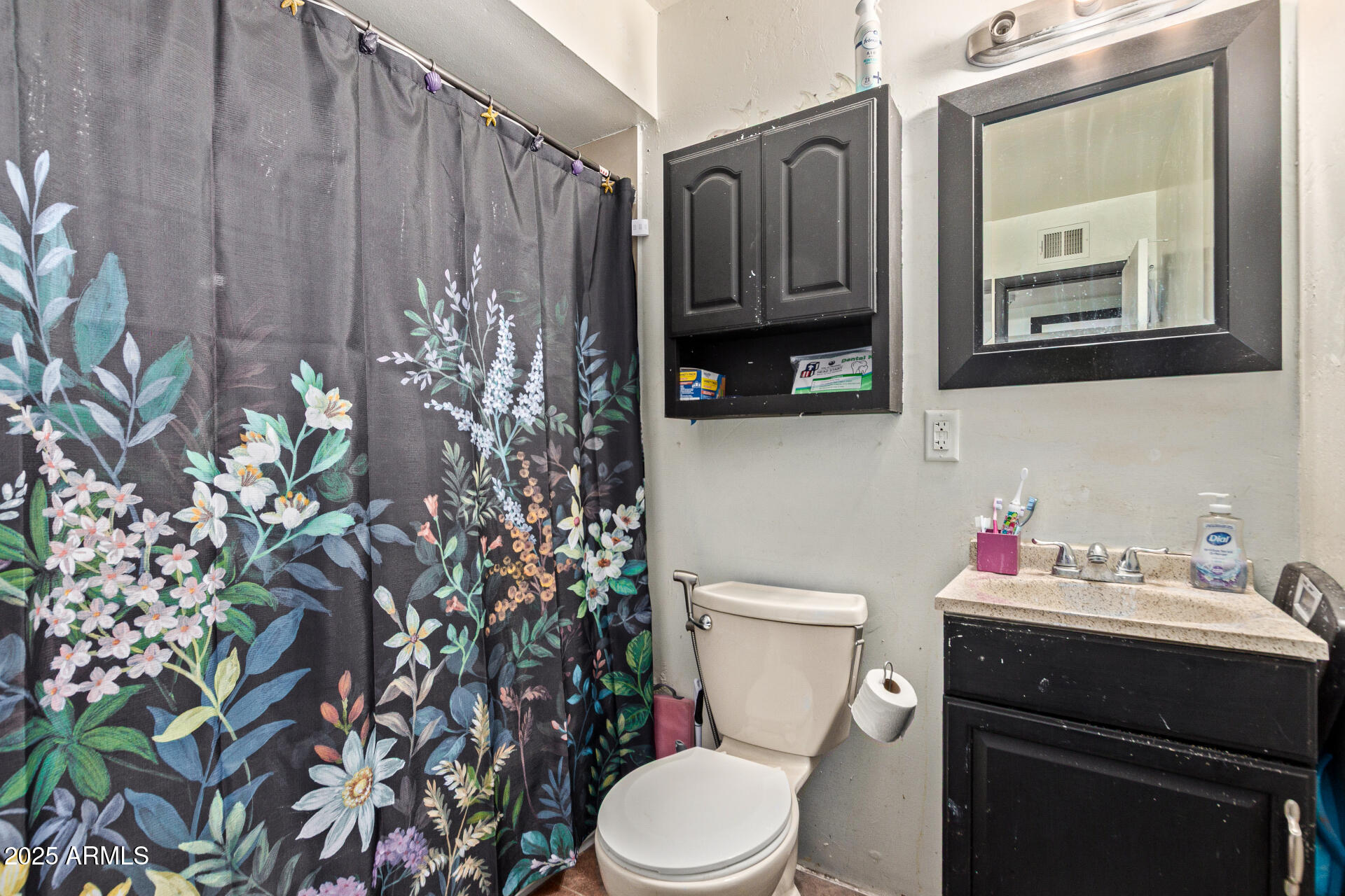 5439 West Osborn Road Phoenix, AZ 85031 - Photo 15 of 22 a bathroom with a toilet sink and mirror
