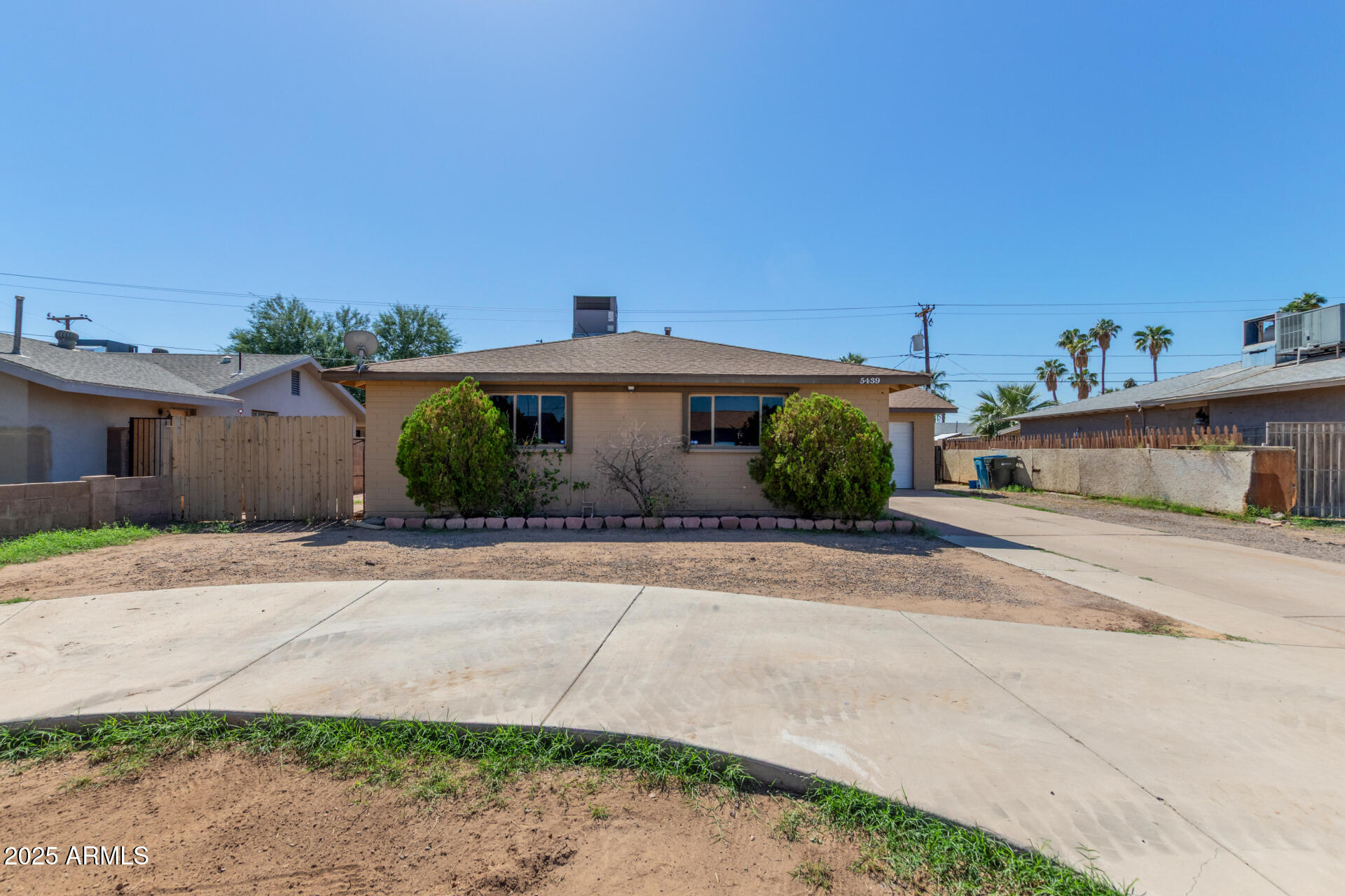 5439 West Osborn Road Phoenix, AZ 85031 - Photo 2 of 22 a front view of a house with a yard and garage