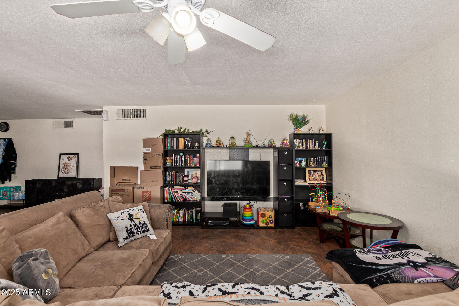 5439 West Osborn Road Phoenix, AZ 85031 - Photo 4 of 22 a living room with furniture and a flat screen tv