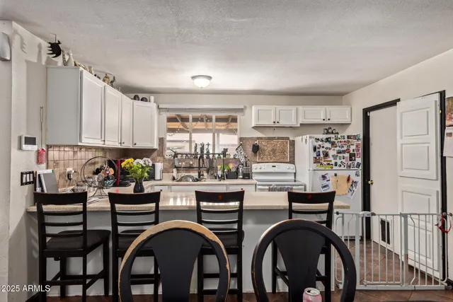 a kitchen with sink and cabinets