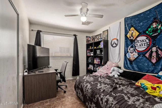 a bedroom with a bed and a dresser in it