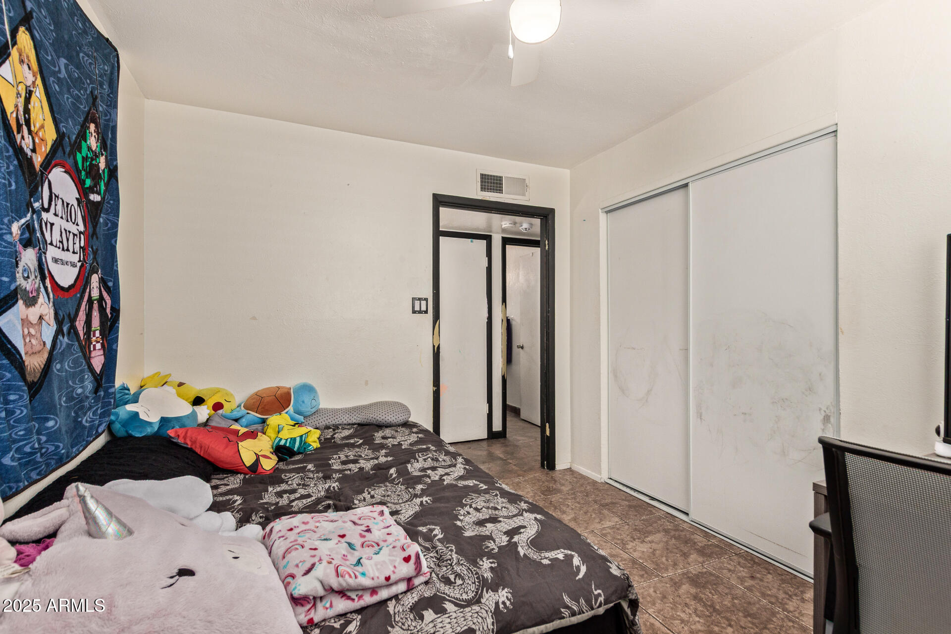 5439 West Osborn Road Phoenix, AZ 85031 - Photo 10 of 22 a bedroom with a bed and a dresser in it