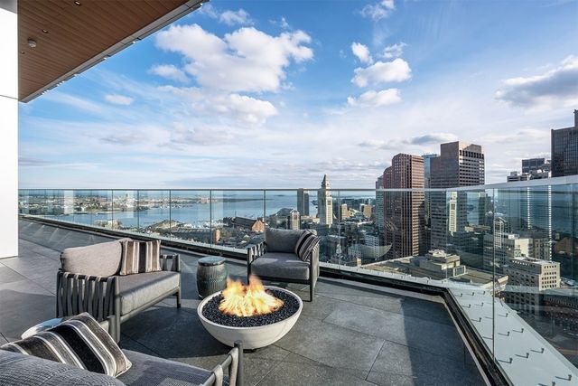 a view of a balcony with dining table and chairs