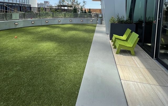 a bedroom with a bed a large window and walk in closet