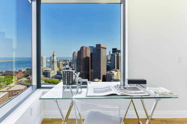 a view of a dining room with furniture and a floor to ceiling window