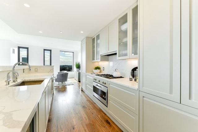 a kitchen with a sink stove and cabinets