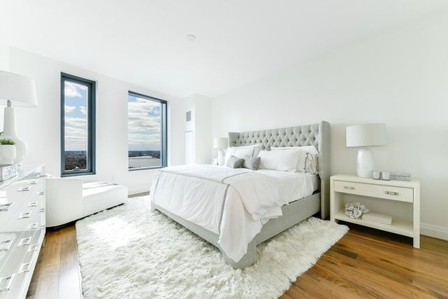 a spacious bedroom with a bed and a couch