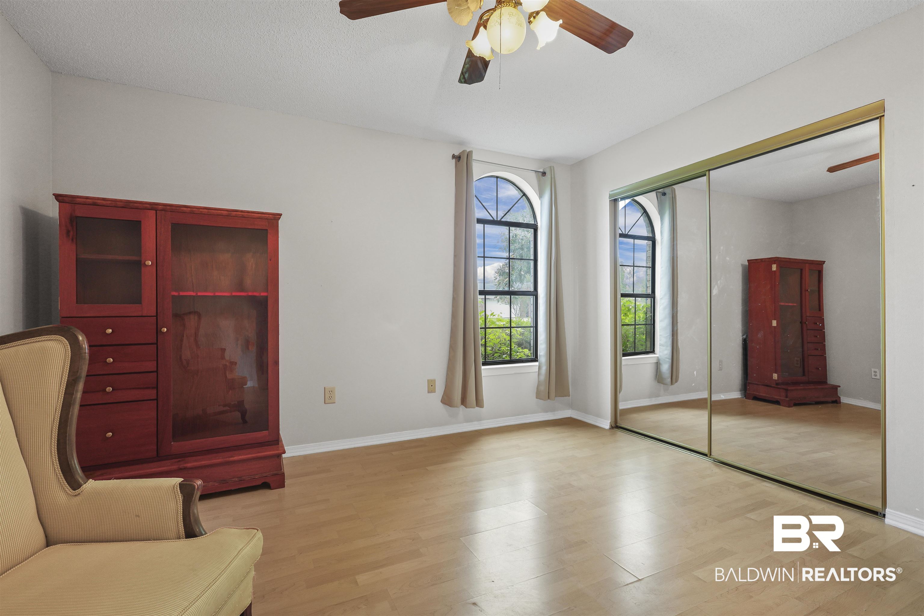 507 West Amanda Avenue Foley, AL 36535 - Photo 12 of 23 Unfurnished room featuring a textured ceiling, light hardwood / wood-style floors, and ceiling fan