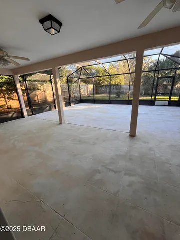 a view of an empty room with a floor to ceiling window