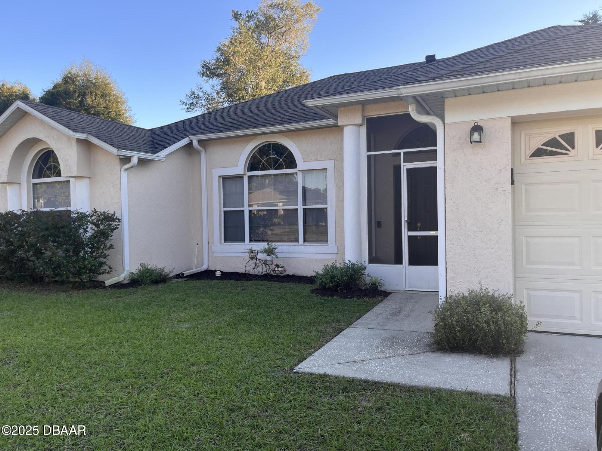 612 John Thomas Avenue DeLand, FL 32724 - Photo 2 of 11 a front view of a house with a yard