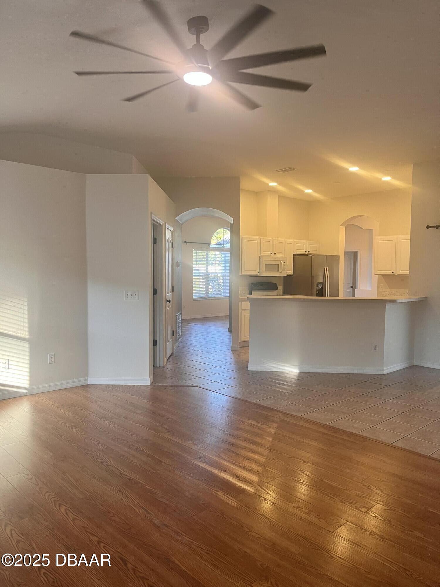 612 John Thomas Avenue DeLand, FL 32724 - Photo 4 of 11 a view of a living room a kitchen and a hard wood floor