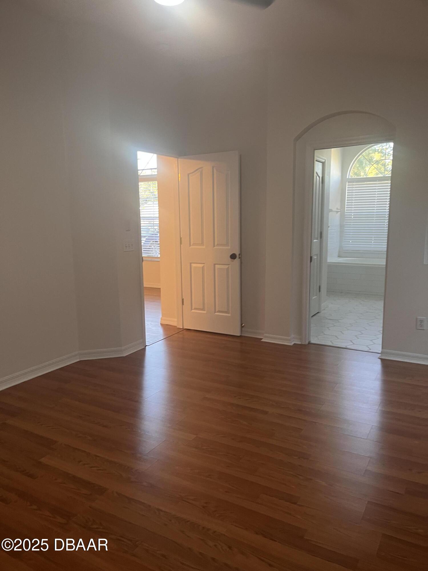 612 John Thomas Avenue DeLand, FL 32724 - Photo 7 of 11 a view of an empty room with wooden floor and a window