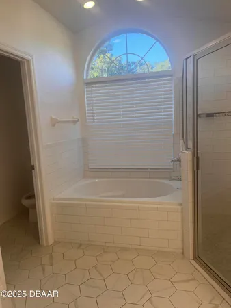 a view of bathroom with bathtub and shower