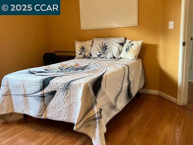 a bed sitting in a bedroom next to a bathroom