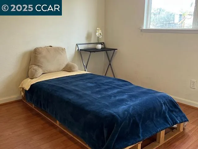 a bedroom with a bed and window