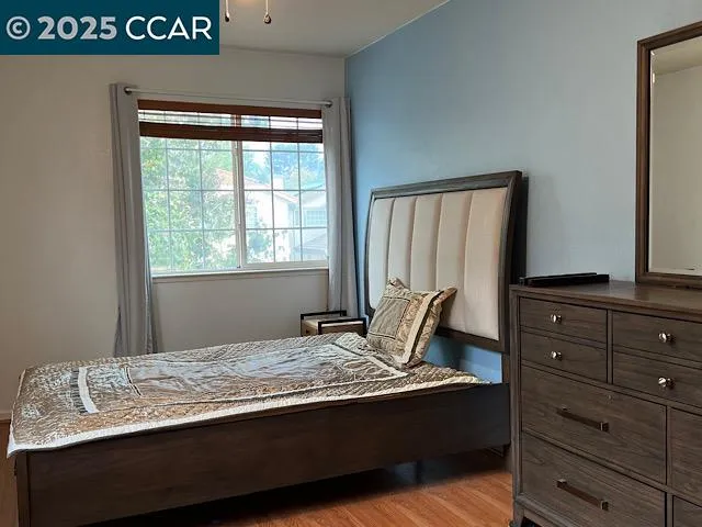 a bedroom with a bed and window