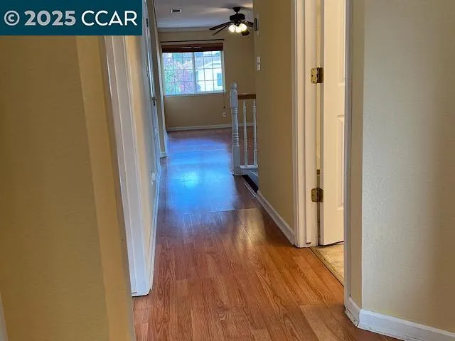 a view of hallway with wooden floor