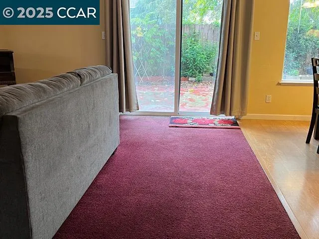 a living room with a floor to ceiling window and a floor to ceiling window