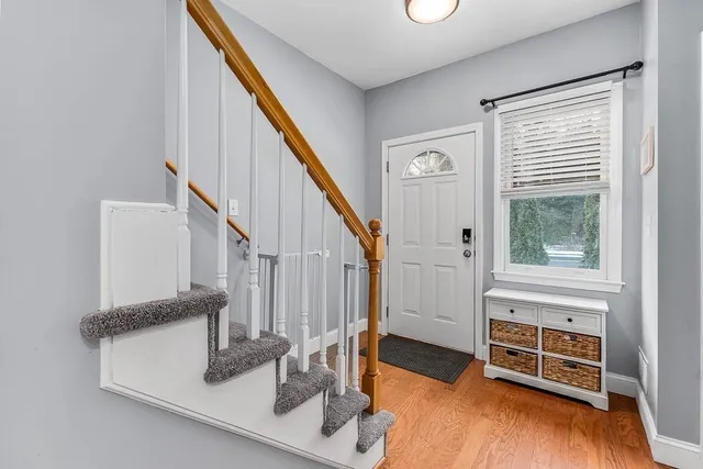 a view of entryway and hall with wooden floor