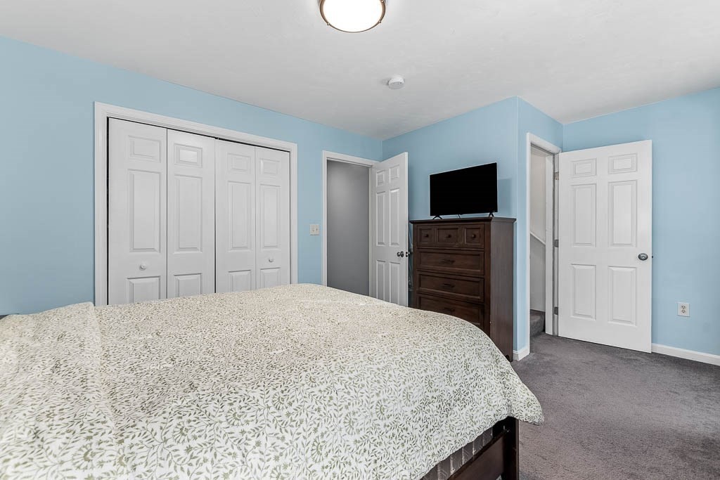 272 Union Street, Unit 272 Walpole, MA 02032 - Photo 15 of 27 a bedroom with a bed and a flat screen tv